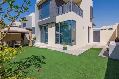 a house with a yard with green grass at Elegant 4 bedrooms plus maid Villa in the Heart of Dubai Hills in Dubai
