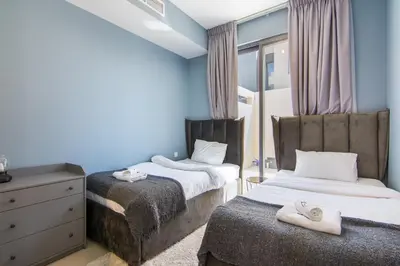 a bedroom with two beds with towels on them at Elegant 4 bedrooms plus maid Villa in the Heart of Dubai Hills in Dubai