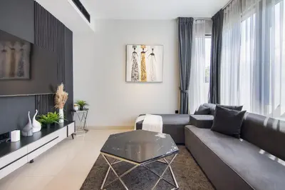 a living room with a couch and a table at Elegant 4 bedrooms plus maid Villa in the Heart of Dubai Hills in Dubai