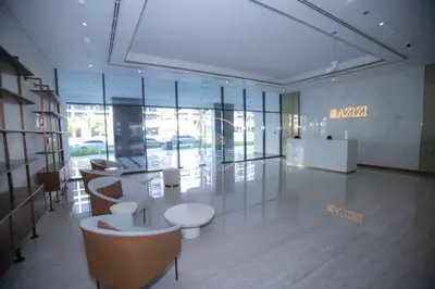 a lobby with tables and chairs in a building at 3BHK Apartment located in Azizi riviera 34 in Dubai