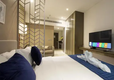 a hotel room with a bed and a flat screen tv at Stunning Pool View DAMAC Prive, Business Bay in Dubai