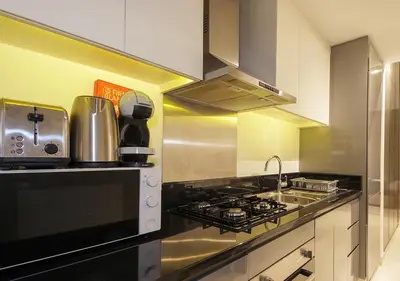 a kitchen with a stove and a sink at Stunning Pool View DAMAC Prive, Business Bay in Dubai