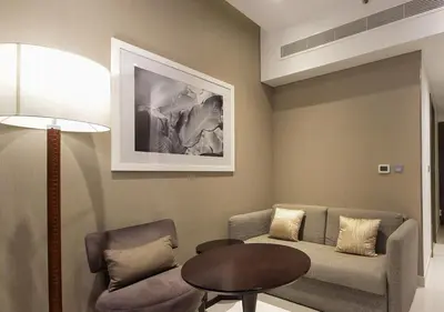 a living room with a couch and a table at Stunning Pool View DAMAC Prive, Business Bay in Dubai
