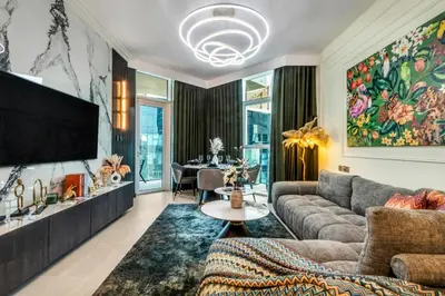 a living room with a couch and a tv at The Smart Concierge - Urban Oasis by Missoni in Dubai