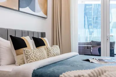 a bedroom with a bed with pillows and a window at The Smart Concierge - Urban Oasis by Missoni in Dubai
