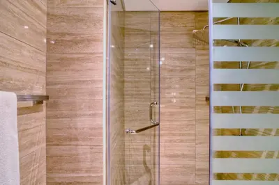 a shower with a glass door in a bathroom at The Smart Concierge - Urban Oasis by Missoni in Dubai