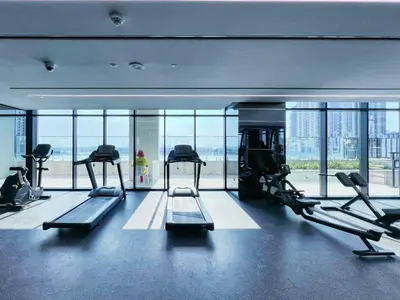 a gym with treadmills and ellipticals in a building at The Smart Concierge - Urban Oasis by Missoni in Dubai
