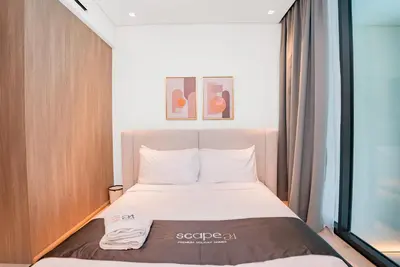 a bed in a small room with a window at Escape24 Cozy Studio with Pool View in JVC in Dubai