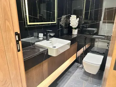 a bathroom with a sink and a toilet at Spacious Luxury 1br Jvc Balcony & Pool in Dubai