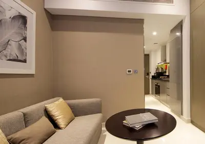 a living room with a couch and a table at Elegant Studio with Canal Views DAMAC Prive in Dubai