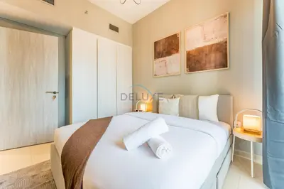 a bedroom with a white bed with two towels on it at City Views 1BR with Balcony Near Dubai Water Canal, Zada Tower, Business Bay by Deluxe Holiday Homes in Dubai