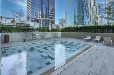 a swimming pool in a city with tall buildings at City Views 1BR with Balcony Near Dubai Water Canal, Zada Tower, Business Bay by Deluxe Holiday Homes in Dubai