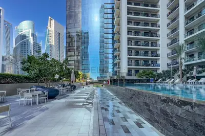 a swimming pool in a city with tall buildings at City Views 1BR with Balcony Near Dubai Water Canal, Zada Tower, Business Bay by Deluxe Holiday Homes in Dubai