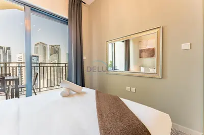 a bedroom with a bed and a large window at City Views 1BR with Balcony Near Dubai Water Canal, Zada Tower, Business Bay by Deluxe Holiday Homes in Dubai
