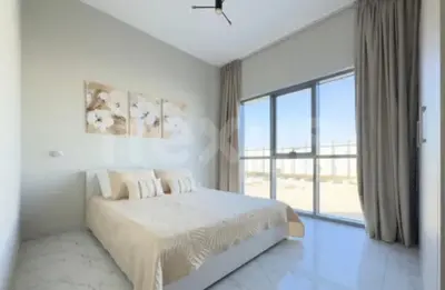 a white bedroom with a bed and a large window at B&B retro in Dubai
