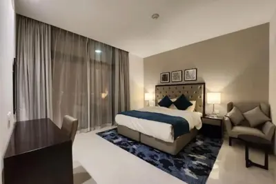 a bedroom with a bed and a desk and a chair at B&B retro in Dubai