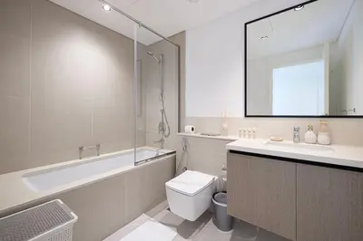 a bathroom with a tub and a toilet and a sink at Mahogany 7 - 2BR 6PAX - Walk to Burj & Dubai Mall in Dubai