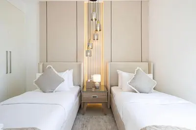 two beds sitting next to each other in a room at Mahogany 7 - 2BR 6PAX - Walk to Burj & Dubai Mall in Dubai