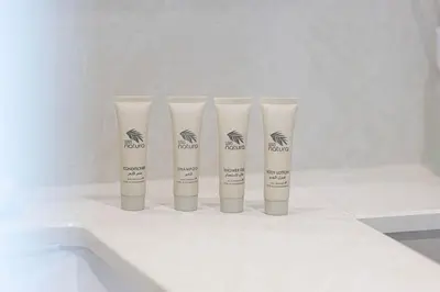 a group of four tubes of sunscreen sitting on a counter at Mahogany 7 - 2BR 6PAX - Walk to Burj & Dubai Mall in Dubai