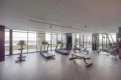 a gym with treadmills and exercise equipment in a building at Mahogany 6 - 2BR 8PAX - Infinity Pool & High-floor in Dubai