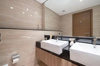 a bathroom with two sinks and a mirror at Mahogany 6 - 2BR 8PAX - Infinity Pool & High-floor in Dubai