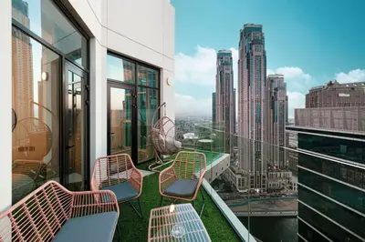 a balcony with benches and a view of a city at Mahogany 5 - 2BR 6PAX - Infinity Pool & High-floor in Dubai