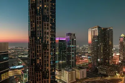 a city skyline with tall skyscrapers at night at Mahogany 5 - 2BR 6PAX - Infinity Pool & High-floor in Dubai