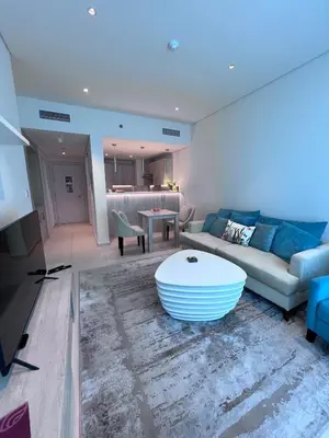 a living room with a couch and a table at Stunning 1 bedroom apartment in Seven Palm Dubai in Dubai
