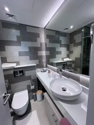a bathroom with a white sink and a toilet at Stunning 1 bedroom apartment in Seven Palm Dubai in Dubai