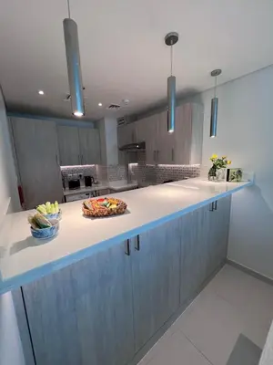 a kitchen with a counter with a bowl of fruit on it at Stunning 1 bedroom apartment in Seven Palm Dubai in Dubai