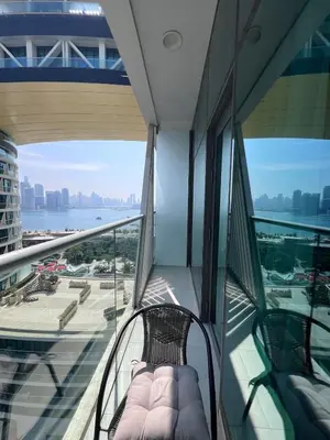 a balcony in a building with a chair on it at Stunning 1 bedroom apartment in Seven Palm Dubai in Dubai