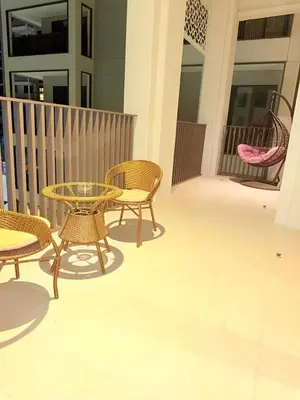 a patio with a table and chairs on a balcony at 1 Bed With Private Beach Access In Dubai Creek Harbour in Dubai