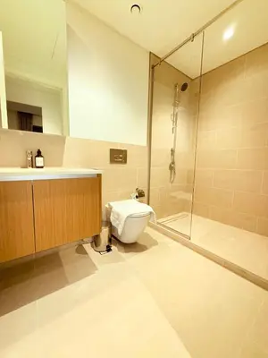 a bathroom with a toilet and a shower and a sink at 1 Bed With Private Beach Access In Dubai Creek Harbour in Dubai