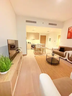 a living room with a couch and a table at 1 Bed With Private Beach Access In Dubai Creek Harbour in Dubai