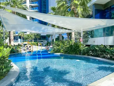 a swimming pool with a water slide in a building at 2BR Apartment in Paramount Tower in Dubai