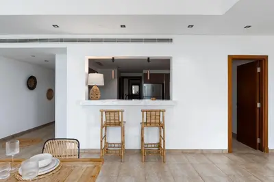 a living room with two chairs and a bar at Marina Residence 4, Palm Jumeirah - Mint Stay in Dubai
