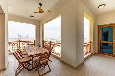 a dining room with a table and chairs on a balcony at Marina Residence 4, Palm Jumeirah - Mint Stay in Dubai