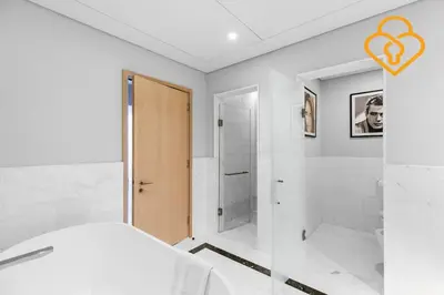 a white bedroom with a bed and a shower at Keysplease Upgraded Interiors Luxury Palm Tower 1 BR in Dubai