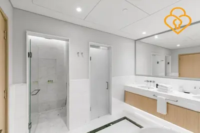a white bathroom with a shower and a sink at Keysplease Upgraded Interiors Luxury Palm Tower 1 BR in Dubai