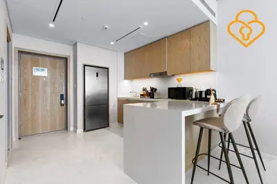 a kitchen with a counter and some chairs in it at Keysplease Upgraded Interiors Luxury Palm Tower 1 BR in Dubai