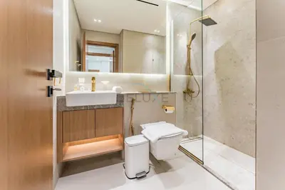 a bathroom with a toilet and a sink and a shower at Skyline and Community Views 1BR with Private Balcony Near Community Park, Binghatti Amber, Jumeirah Village Circle by Deluxe Holiday Homes in Dubai