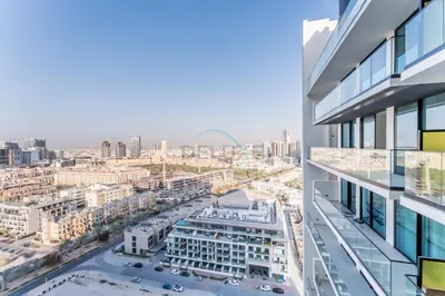 an office building with a view of a city at Skyline and Community Views 1BR with Private Balcony Near Community Park, Binghatti Amber, Jumeirah Village Circle by Deluxe Holiday Homes in Dubai