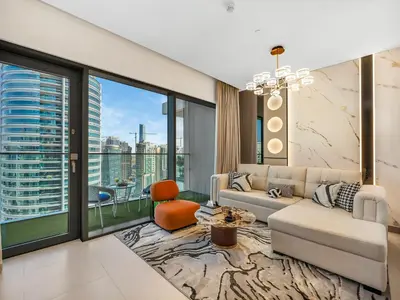 a living room with a couch and a large window at Vida Yacht Club # Up-scale 2BHK # Marina,Sea & Ain View in Dubai
