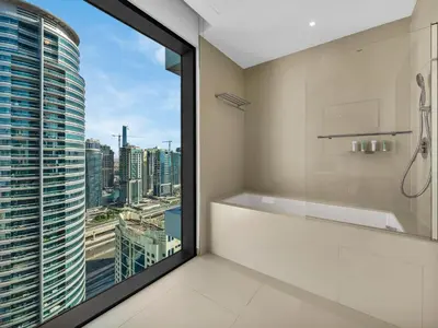 a bathroom with a shower and a view of the city at Vida Yacht Club # Up-scale 2BHK # Marina,Sea & Ain View in Dubai