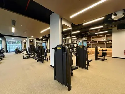 a gym with rows of exercise equipment in a room at Luxury 1BR in Downtown Dubai with Burj Khalifa Views, Pool, Gym & Free Parking in Dubai