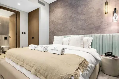 a bedroom with a large bed with towels on it at Luxury 1BR in Downtown Dubai with Burj Khalifa Views, Pool, Gym & Free Parking in Dubai