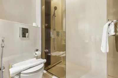 a bathroom with a glass shower with a toilet at Luxury 1BR in Downtown Dubai with Burj Khalifa Views, Pool, Gym & Free Parking in Dubai