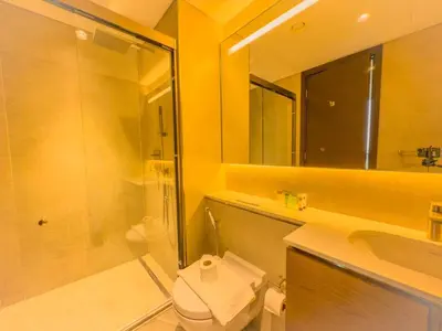a bathroom with a shower and a toilet and a sink at Elegant 2-BR with modern comfort in Dubai