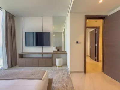 a bedroom with a bed and a tv on the wall at Elegant 2-BR with modern comfort in Dubai