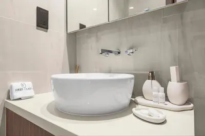 a bathroom with a large white bowl sink on a counter at Luxury 1BR in Business Bay with Burj Khalifa Views, Balcony, Pool and Gym Access in Dubai